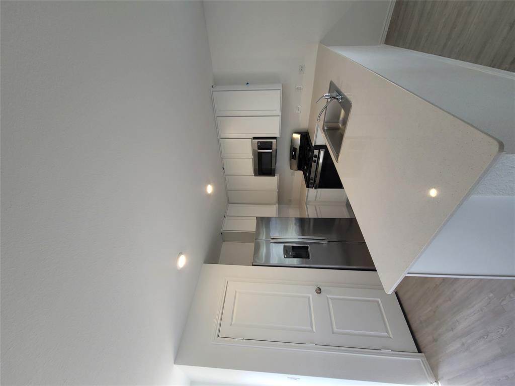 105 Painted Night Road Hutto, TX 78634 - Photo 4 of 8 a kitchen with stainless steel appliances a refrigerator sink and microwave