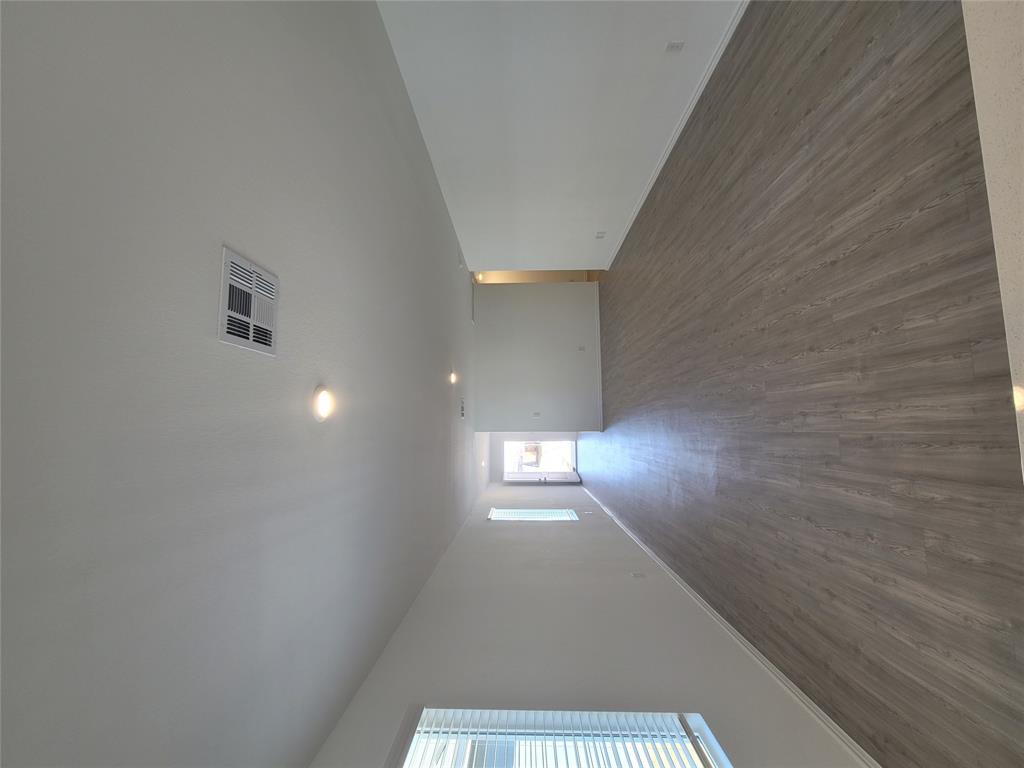 105 Painted Night Road Hutto, TX 78634 - Photo 5 of 8 an empty room with wooden floor and windows