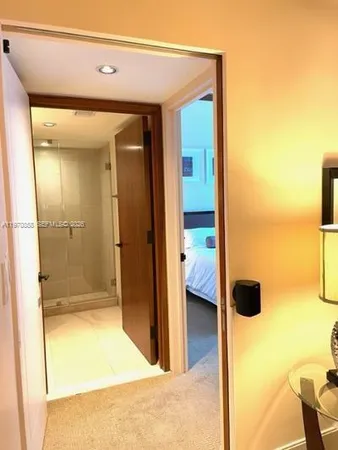 a view of walk in closet and bathroom