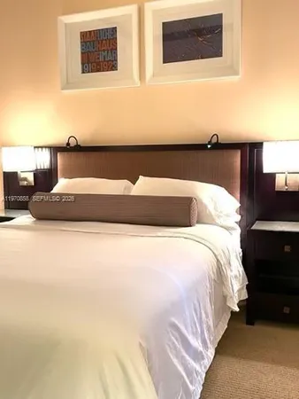 a bedroom with a bed and mirror