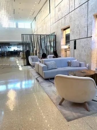 a living room with furniture and a night stand