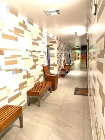 a lobby with furniture and rug