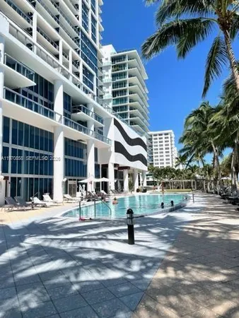 a view of backyard with swimming pool and outdoor seating
