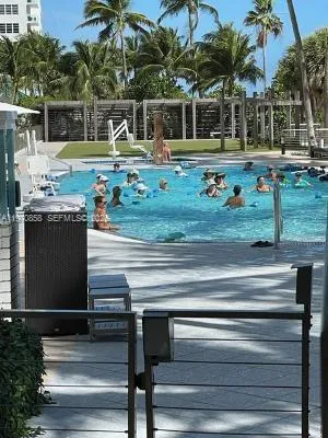 a view of a swimming pool with a fountain in a yard