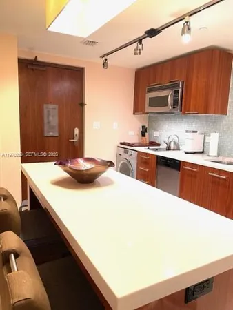 a kitchen with a sink a stove and wooden cabinets