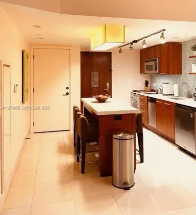 a kitchen with a sink cabinets and appliances