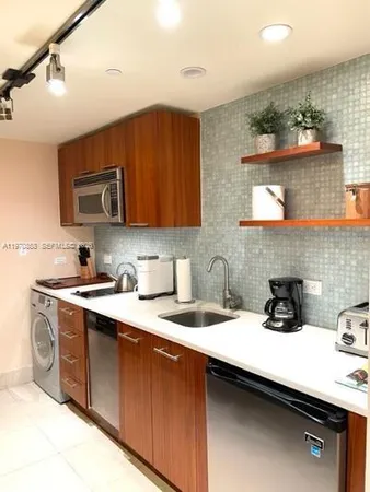 a kitchen with a sink cabinets and stainless steel appliances