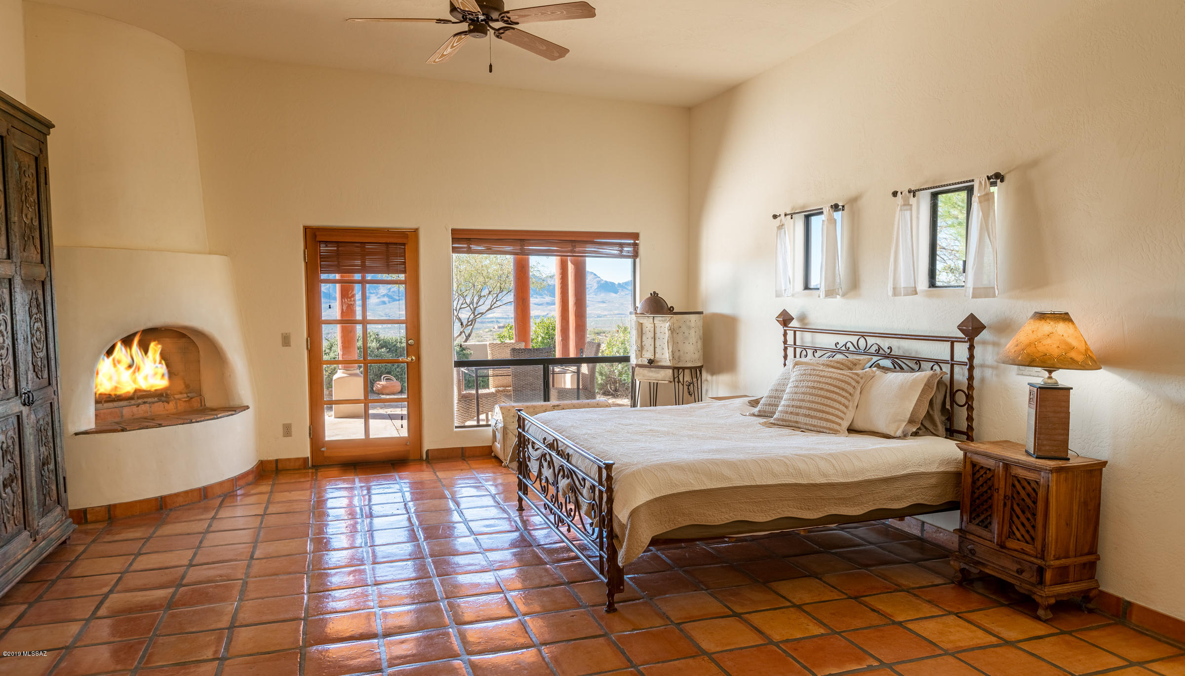 1551 Vía San Cayetano Rio Rico, AZ 85648 - Photo 22 of 29 a bedroom with a bed and a lamp on dresser