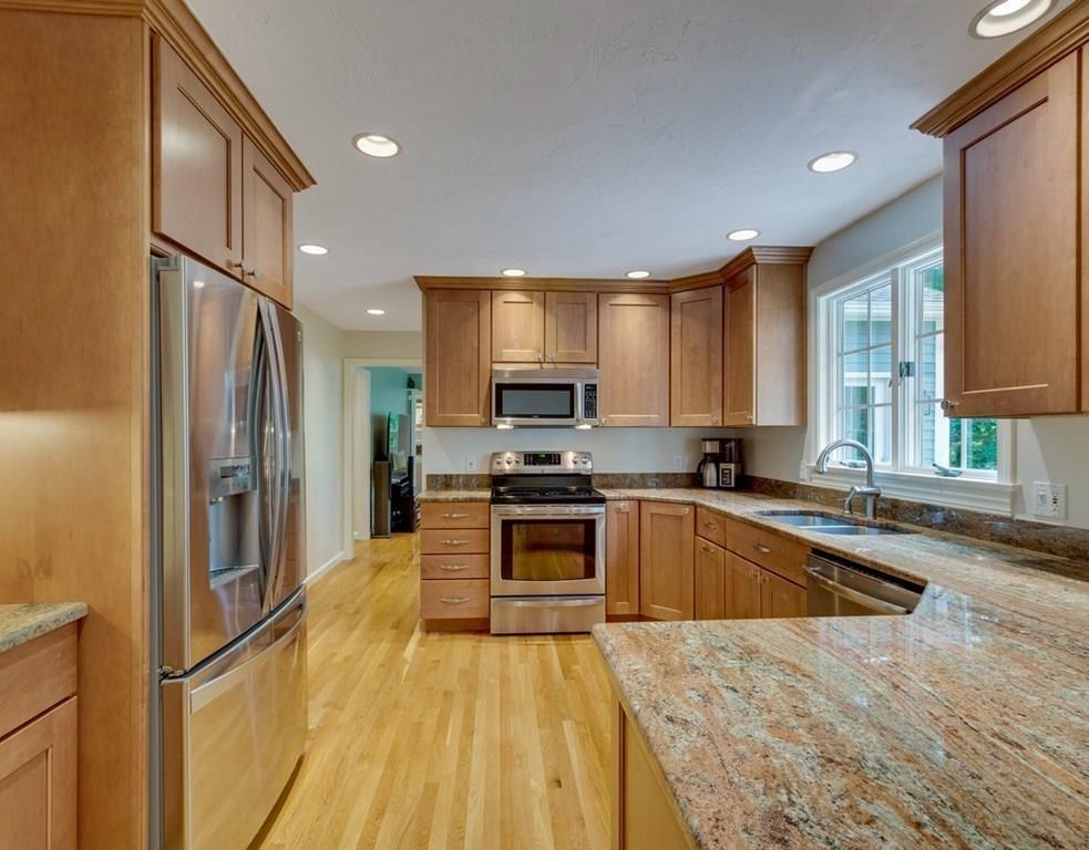 328 Joseph Road Boxborough, MA 01719 - Photo 3 of 34 a kitchen with granite countertop a stove a sink a refrigerator and a microwave