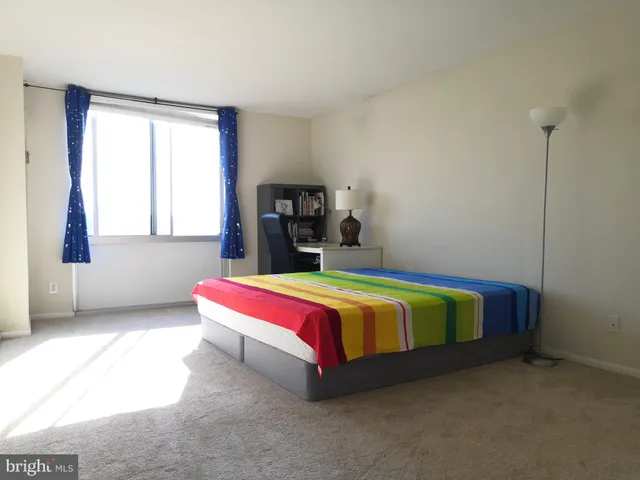 a bedroom with a bed and window