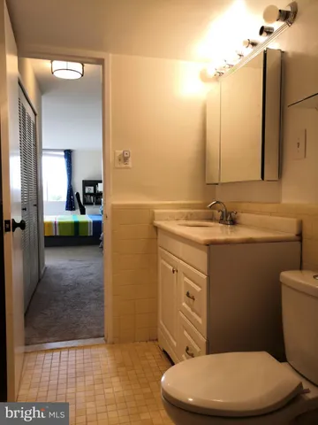 a bathroom with a toilet a sink and mirror