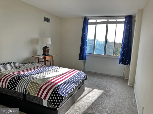 a bedroom with a bed and window