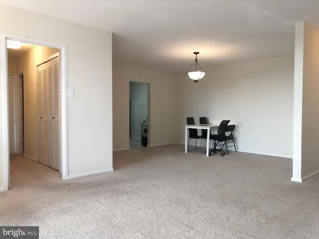 a view of a room with chairs and closet