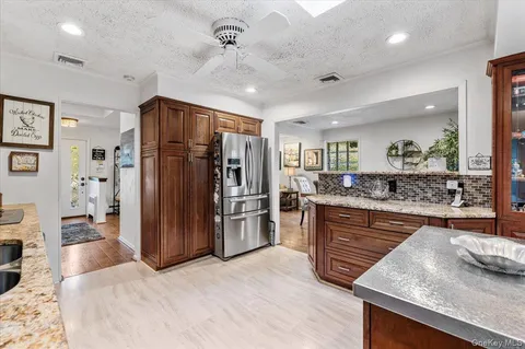 a kitchen with stainless steel appliances granite countertop a refrigerator and a sink