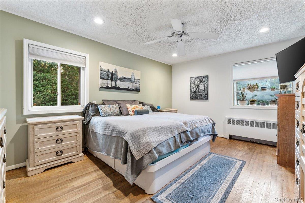 2 Doone Drive Syosset, NY 11791 - Photo 17 of 23 a spacious bedroom with a large bed and a window