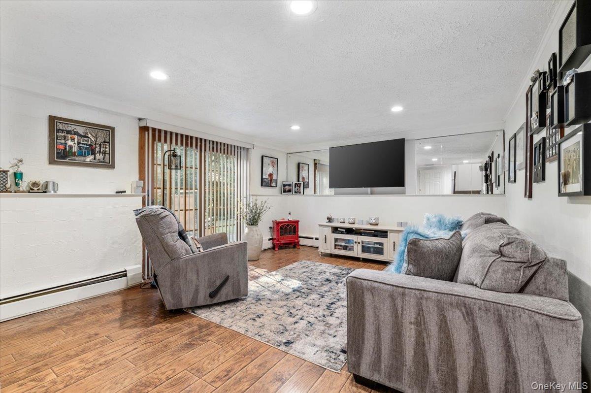 2 Doone Drive Syosset, NY 11791 - Photo 19 of 23 a living room with furniture and a flat screen tv