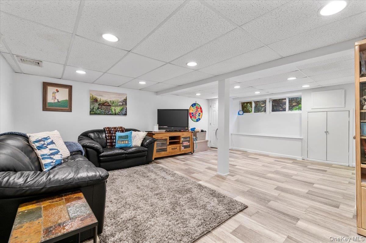 2 Doone Drive Syosset, NY 11791 - Photo 21 of 23 a living room with furniture and a flat screen tv