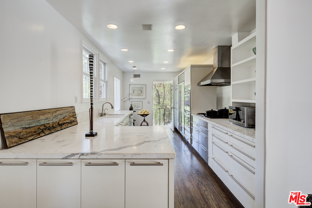 8420 La Tuna Canyon Road Sun Valley, CA 91352 - Photo 12 of 50 a kitchen with kitchen island white cabinets and stainless steel appliances