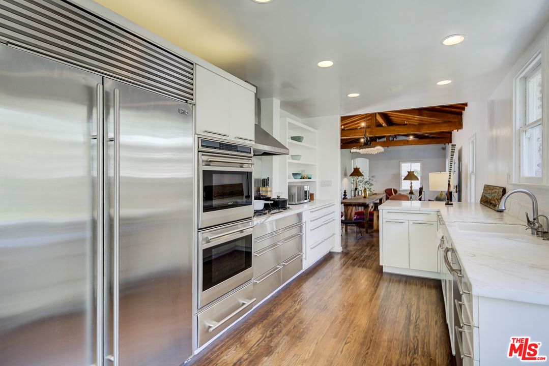 8420 La Tuna Canyon Road Sun Valley, CA 91352 - Photo 16 of 50 a kitchen with kitchen island a counter top space a sink stainless steel appliances and cabinets