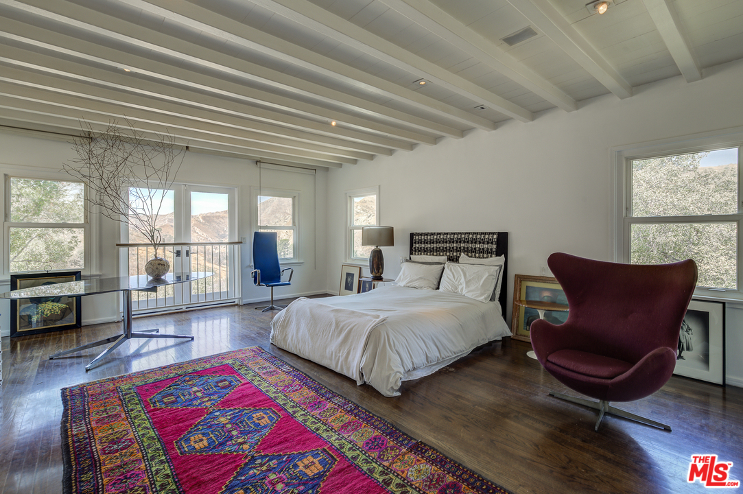 8420 La Tuna Canyon Road Sun Valley, CA 91352 - Photo 18 of 50 a bedroom with a bed a chair and next to a window