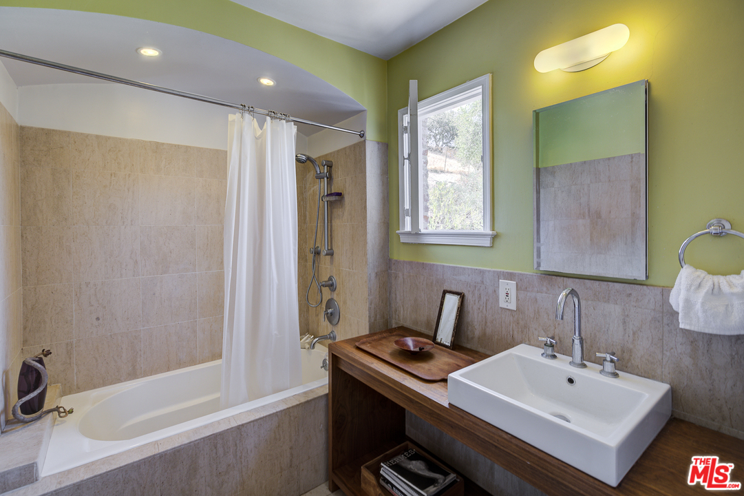 8420 La Tuna Canyon Road Sun Valley, CA 91352 - Photo 26 of 50 a bathroom with a sink mirror and a bathtub