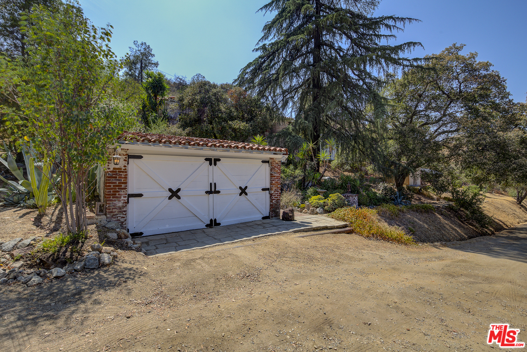 8420 La Tuna Canyon Road Sun Valley, CA 91352 - Photo 38 of 50 a view of a white house with a large tree and a yard