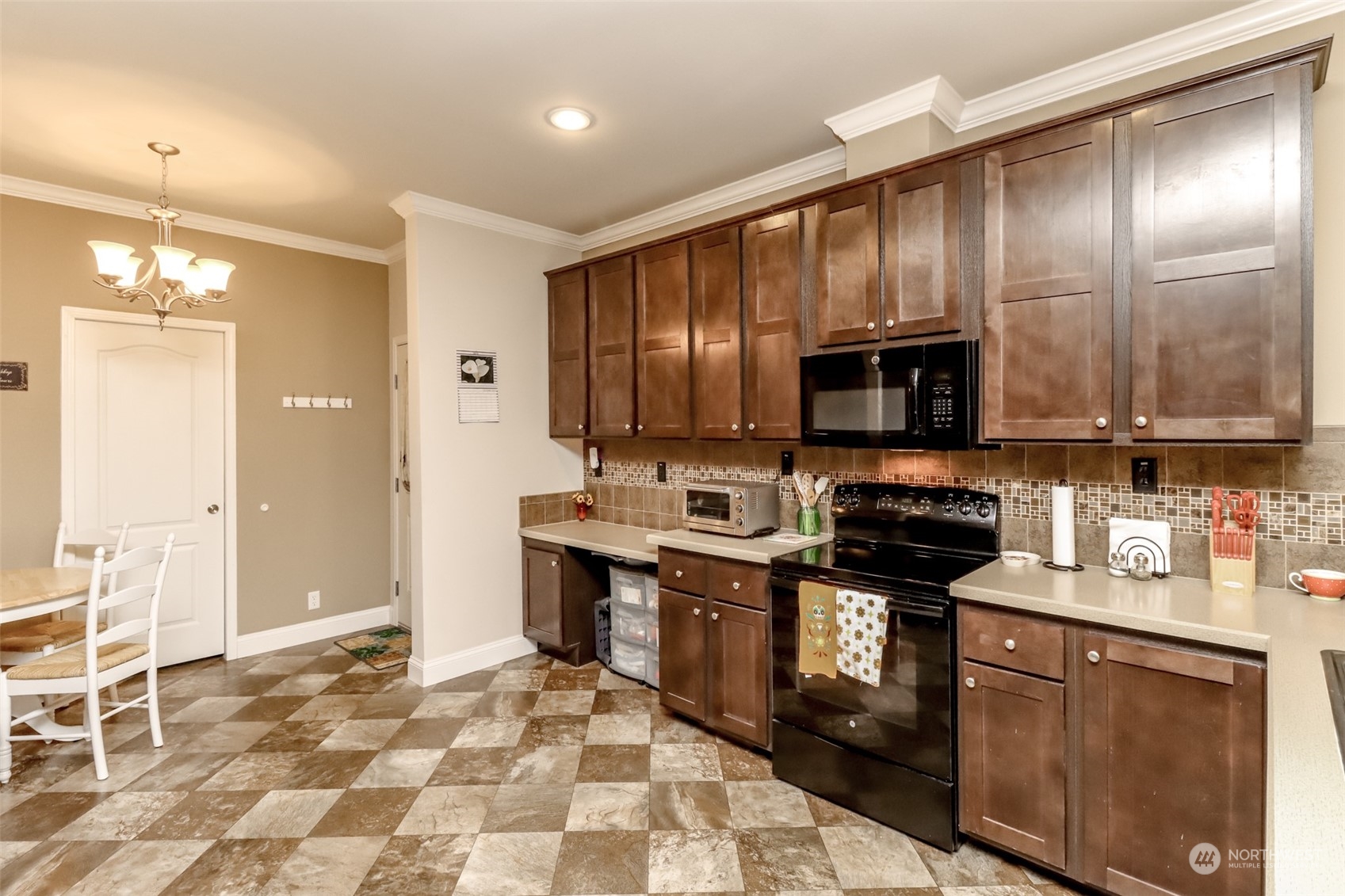 828 Mountain Villa Drive Enumclaw, WA 98022 - Photo 13 of 34 a kitchen with stainless steel appliances a stove sink microwave and cabinets