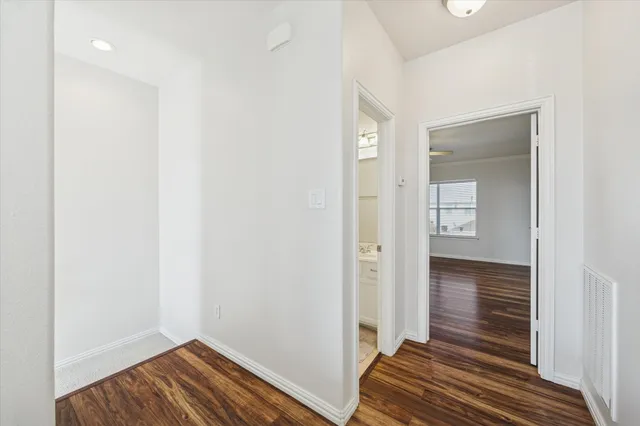 a view of a room with wooden floor