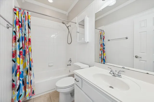 a bathroom with a sink a toilet and a shower curtain