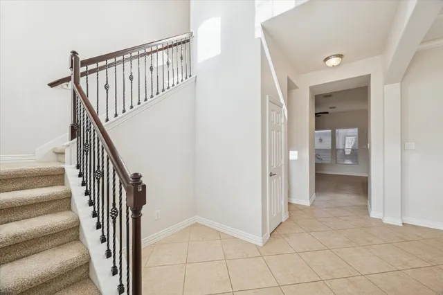 a view of hallway with stairs and a rug