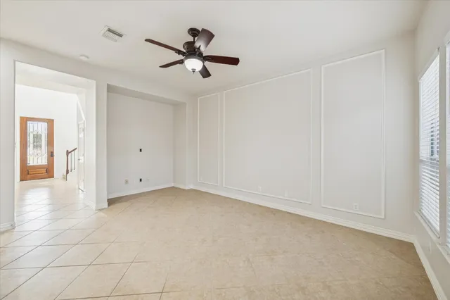a view of a livingroom with a ceiling fan and window
