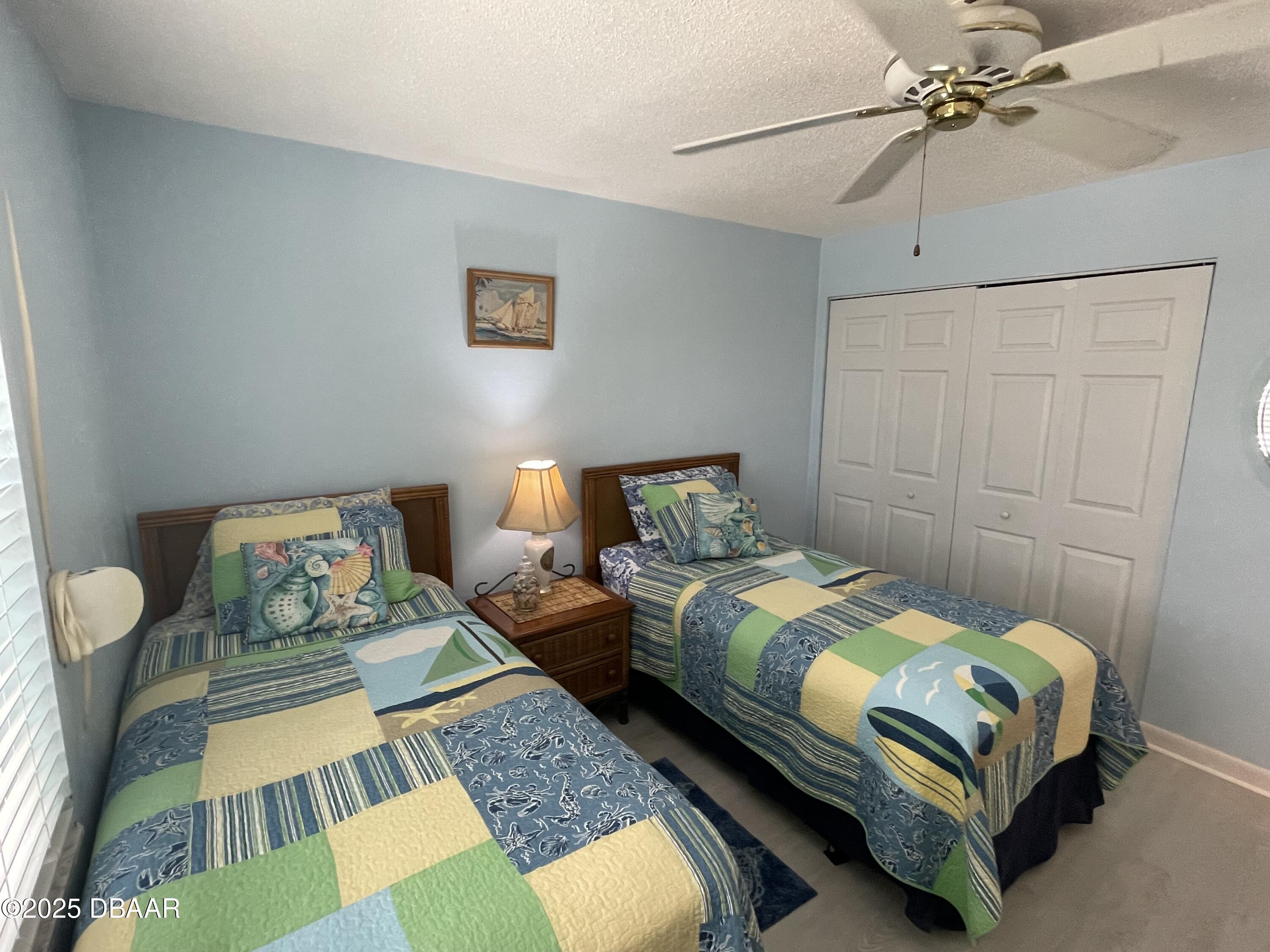 3390 Ocean Shore Boulevard, Unit 101 Ormond Beach, FL 32176 - Photo 16 of 33 a bedroom with a bed and wooden floor