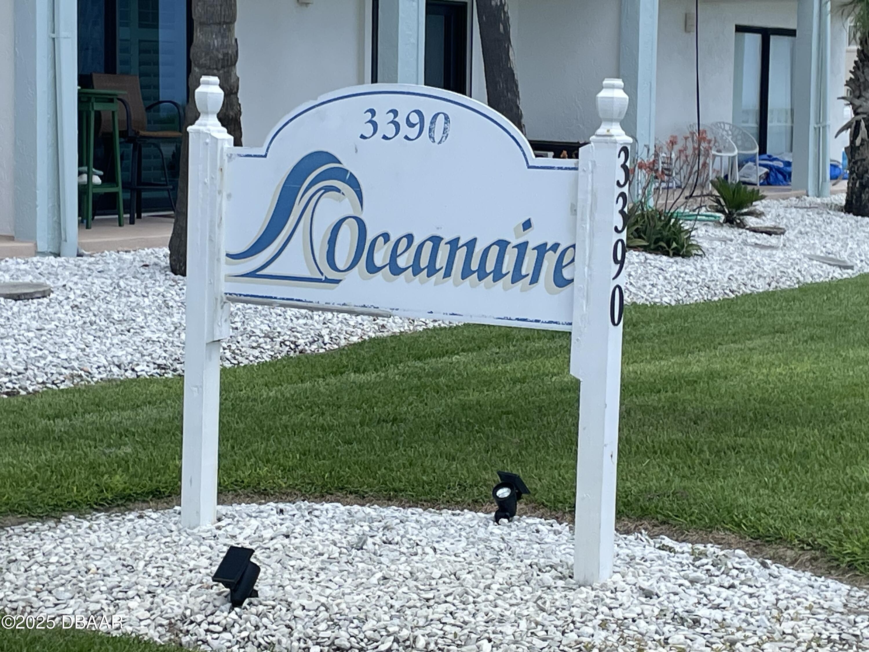 3390 Ocean Shore Boulevard, Unit 101 Ormond Beach, FL 32176 - Photo 2 of 33 a front view of a house with garden