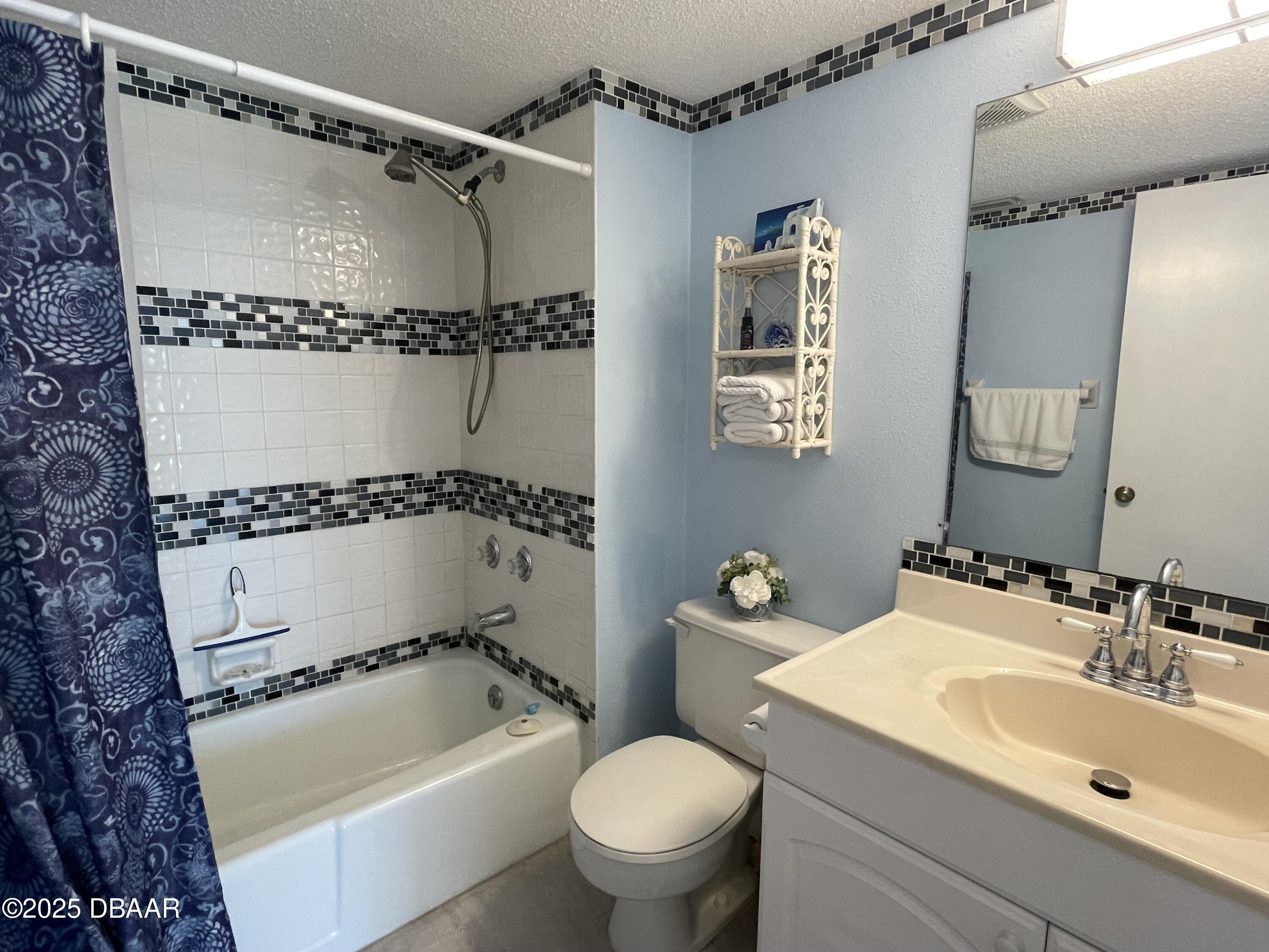 3390 Ocean Shore Boulevard, Unit 101 Ormond Beach, FL 32176 - Photo 24 of 33 a bathroom with a sink toilet and shower