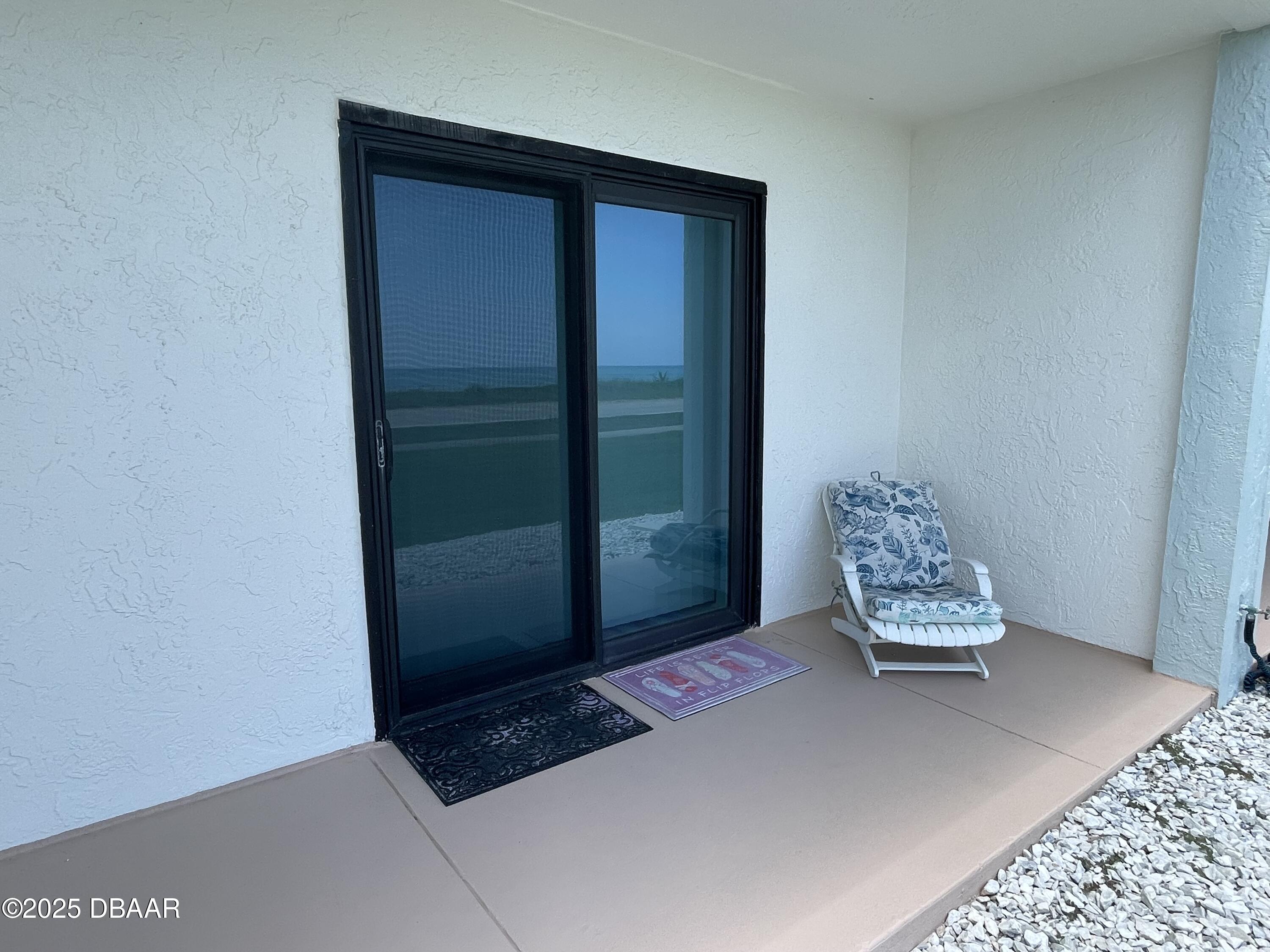 3390 Ocean Shore Boulevard, Unit 101 Ormond Beach, FL 32176 - Photo 26 of 33 a living room with furniture