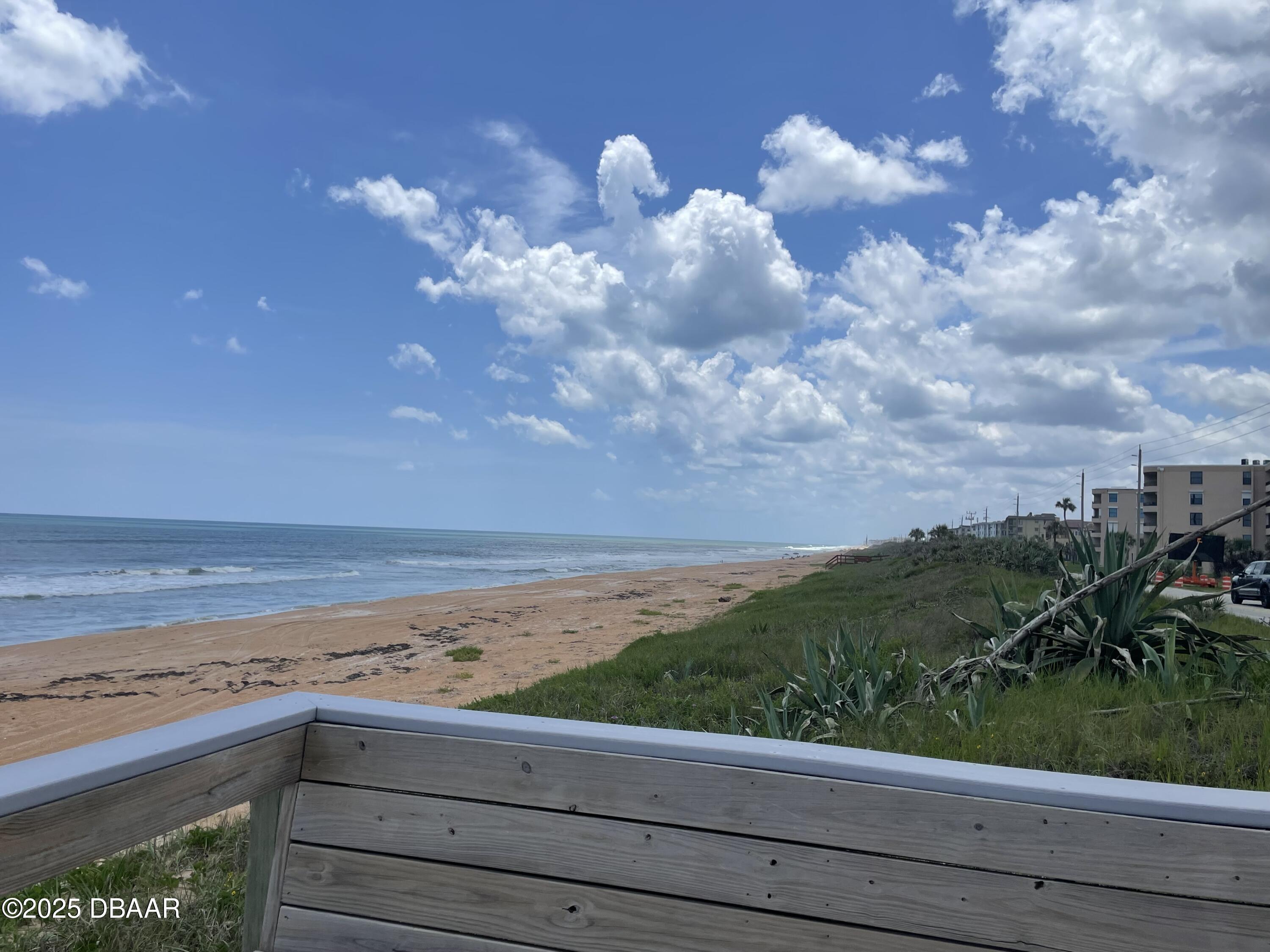 3390 Ocean Shore Boulevard, Unit 101 Ormond Beach, FL 32176 - Photo 32 of 33 a view of a lake and a yard