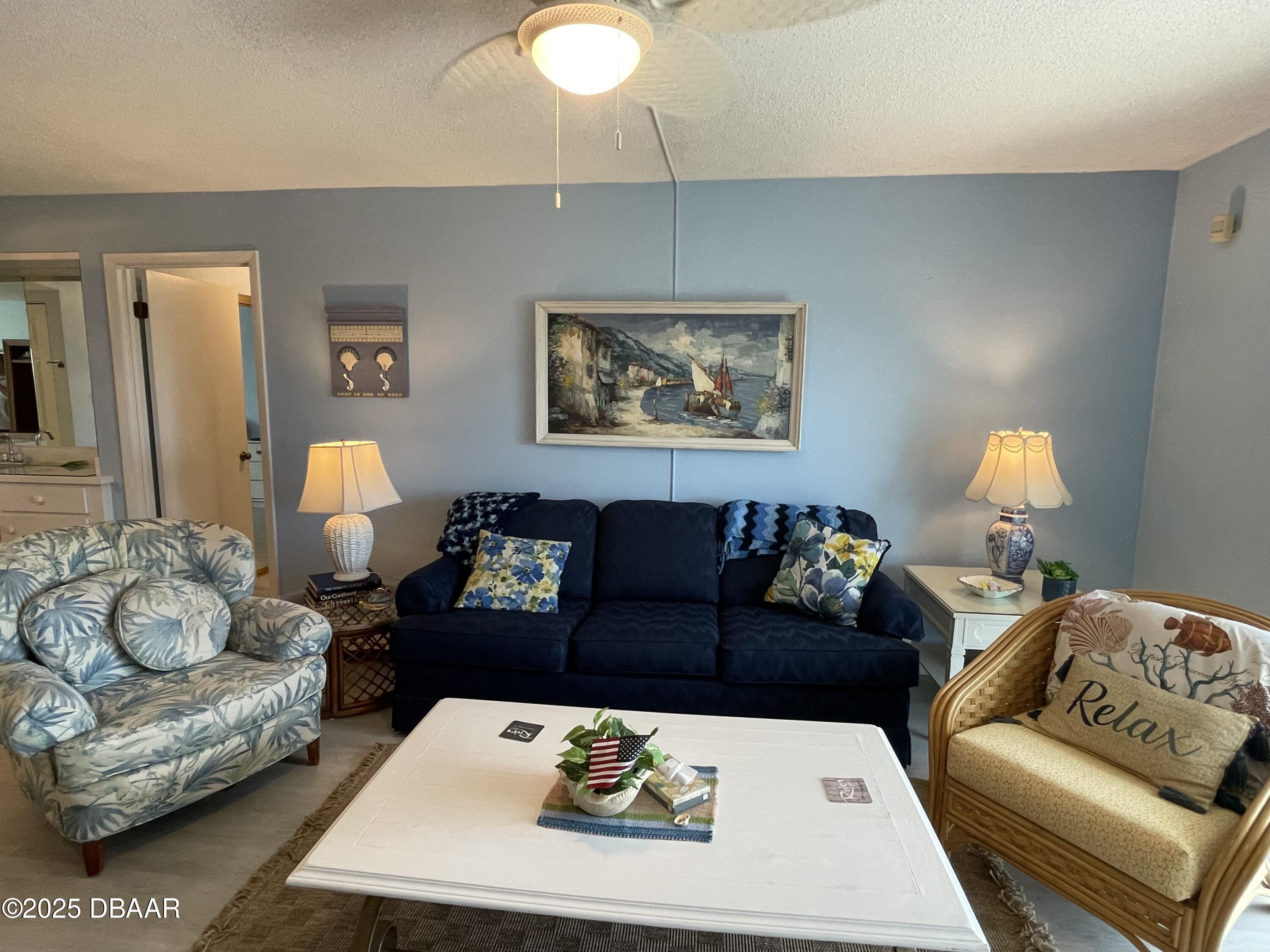 3390 Ocean Shore Boulevard, Unit 101 Ormond Beach, FL 32176 - Photo 6 of 33 a living room with furniture and a couch