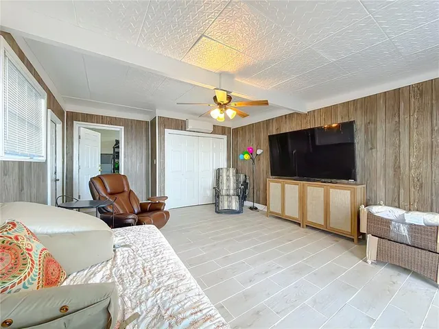 a bedroom with a large bed and a chandelier