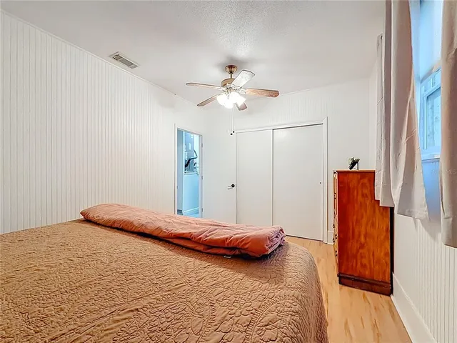a bedroom with a large bed and a chandelier