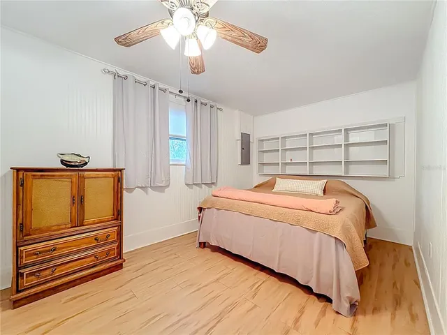 a bedroom with a bed and a flat tv screen on the dresser