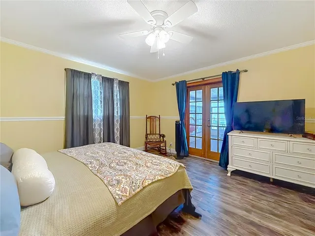a view of a livingroom with furniture and floor to ceiling window