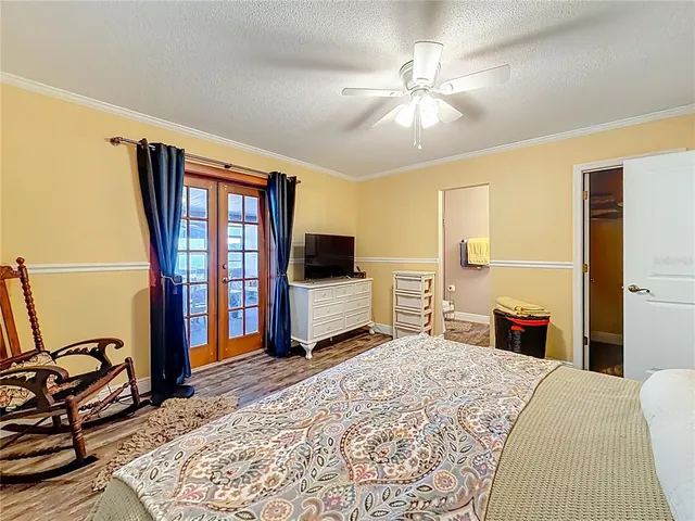 a view of a roof deck with couches and wooden fence