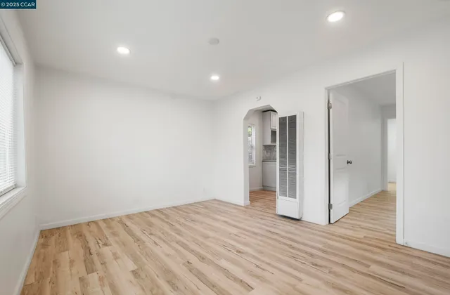 a view of a kitchen with a sink and a refrigerator