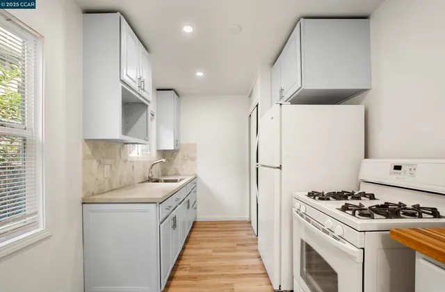 a kitchen with cabinets a washer and dryer