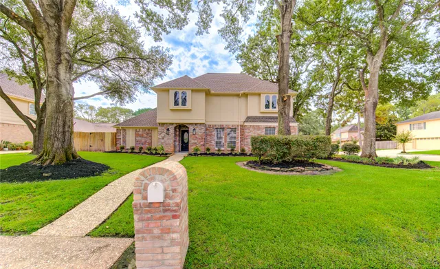 a front view of house with yard and green space
