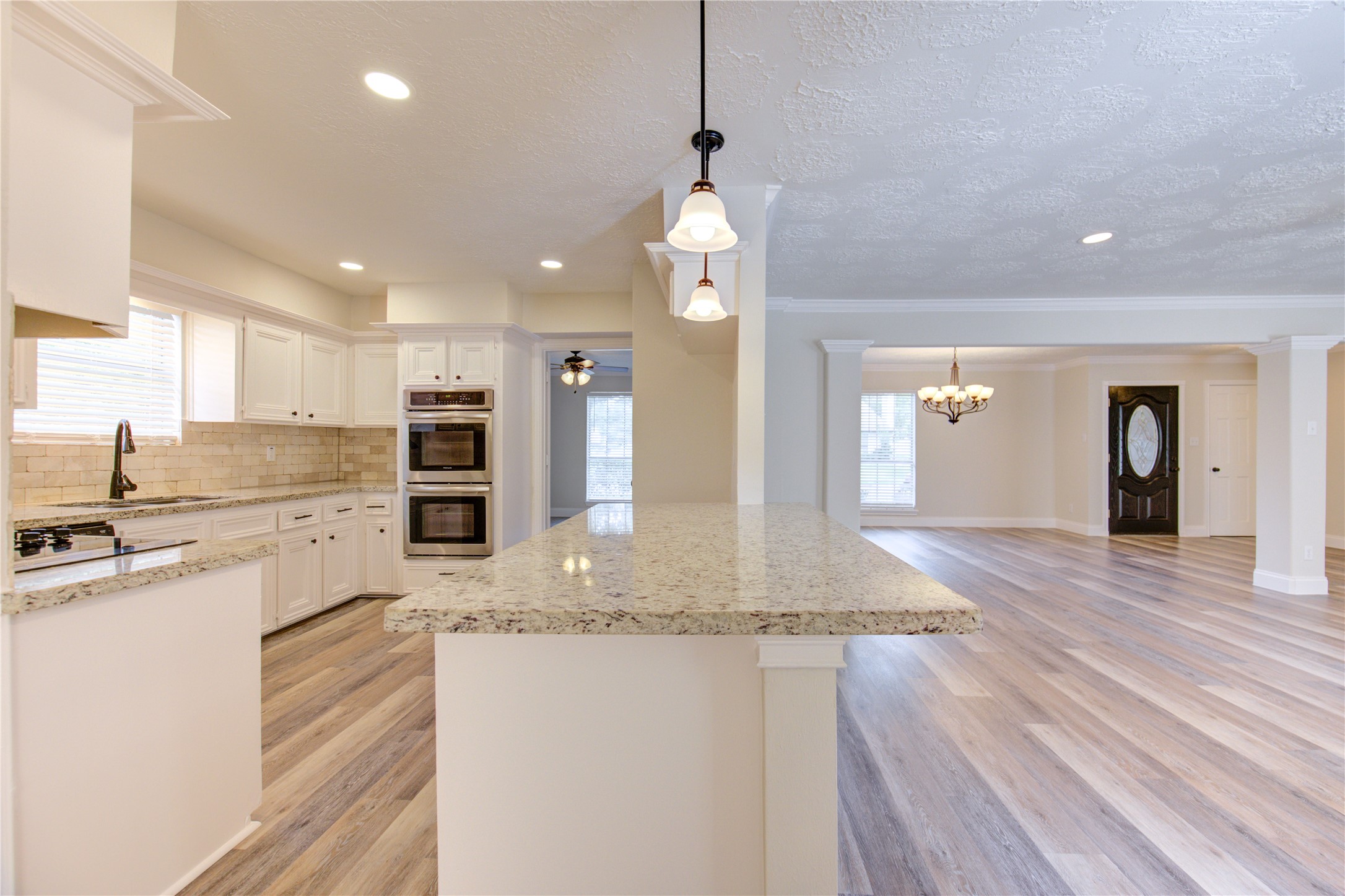 9115 Taidswood Drive Spring, TX 77379 - Photo 13 of 41 The kitchen opens to the family room with extended counter top for barstools.