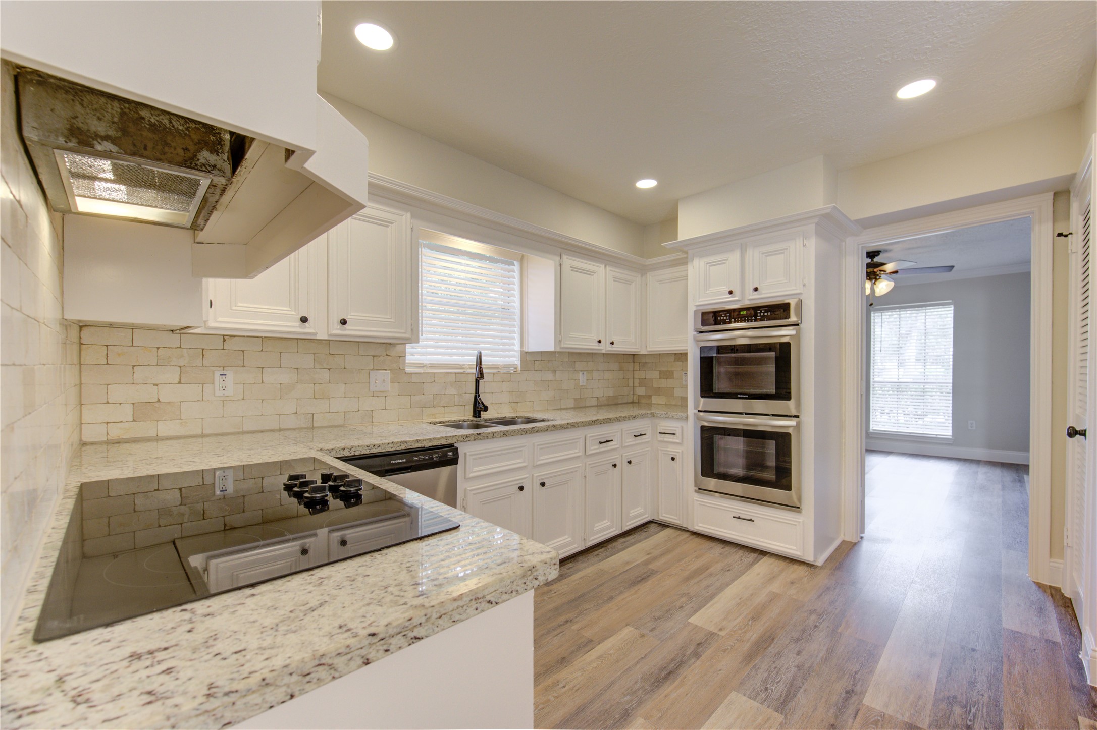 9115 Taidswood Drive Spring, TX 77379 - Photo 14 of 41 The kitchen has a marble backsplash, and beautiful granite counters.