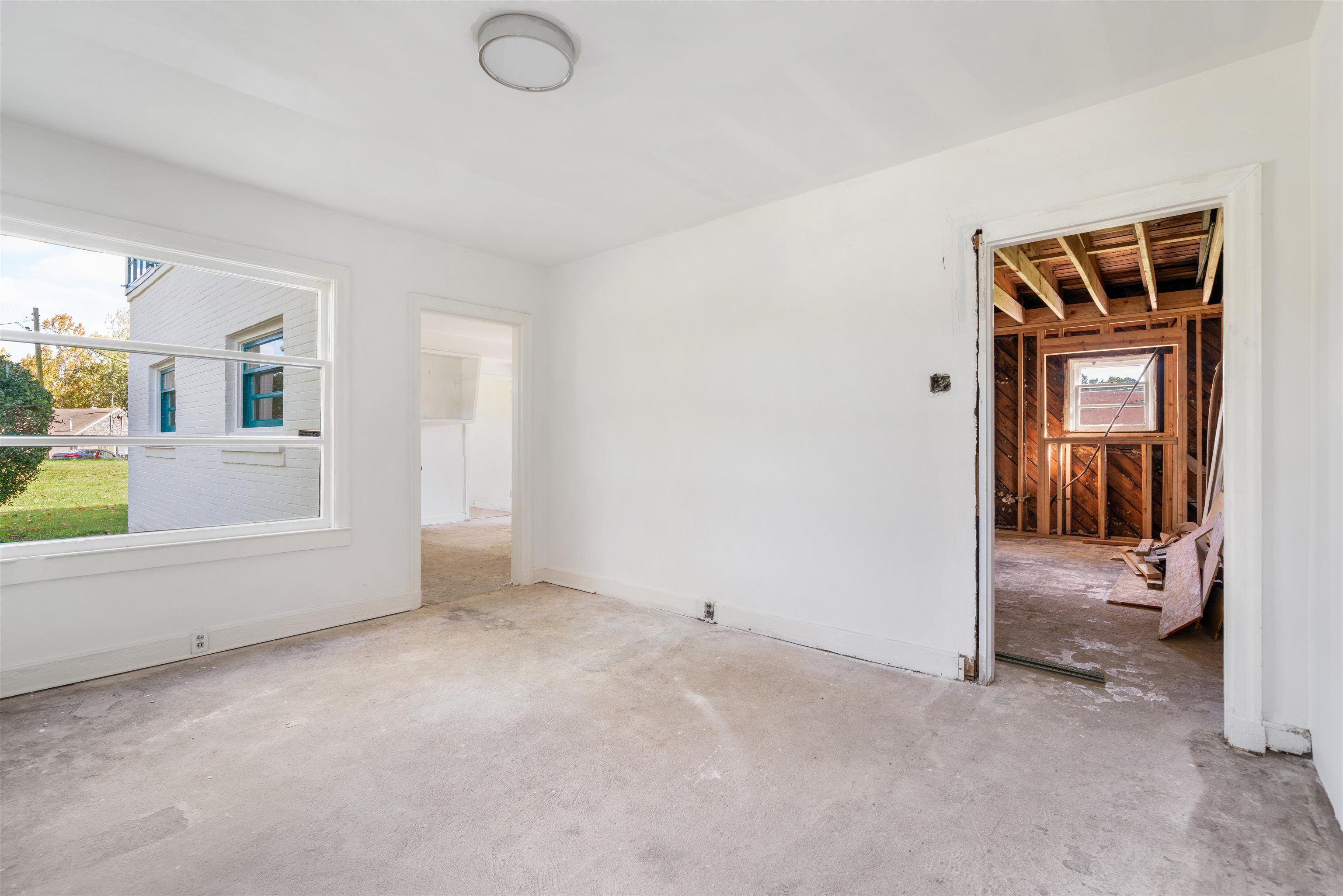 3590 Thomas Street Memphis, TN 38127 - Photo 23 of 39 an empty room with a fireplace and a window