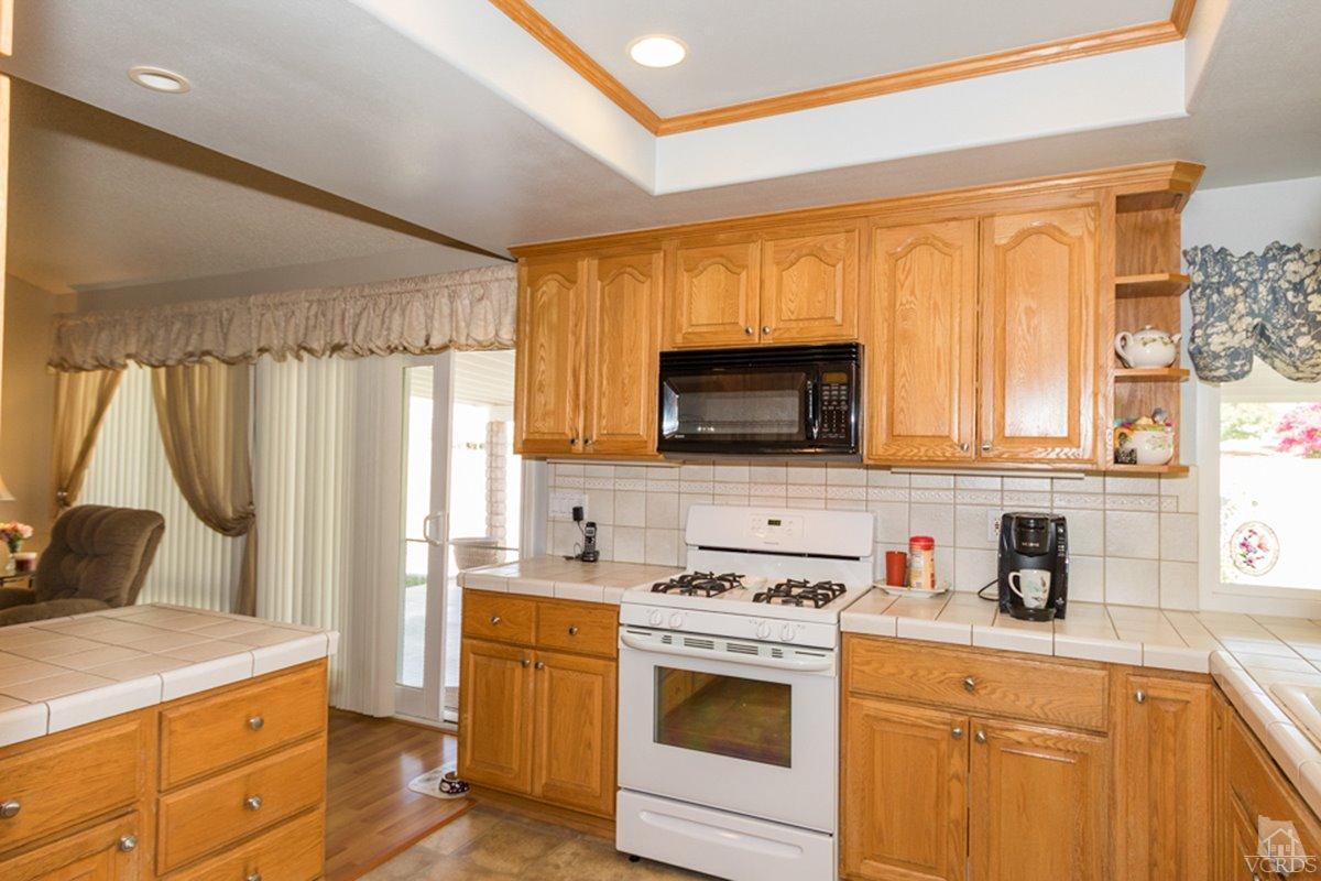 938 Erringer Road Simi Valley, CA 93065 - Photo 13 of 28 a kitchen with a stove a sink and a microwave