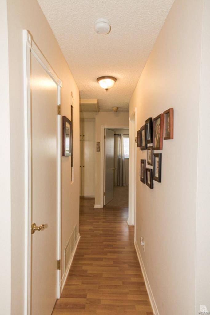 938 Erringer Road Simi Valley, CA 93065 - Photo 15 of 28 a view of a hallway with wooden floor